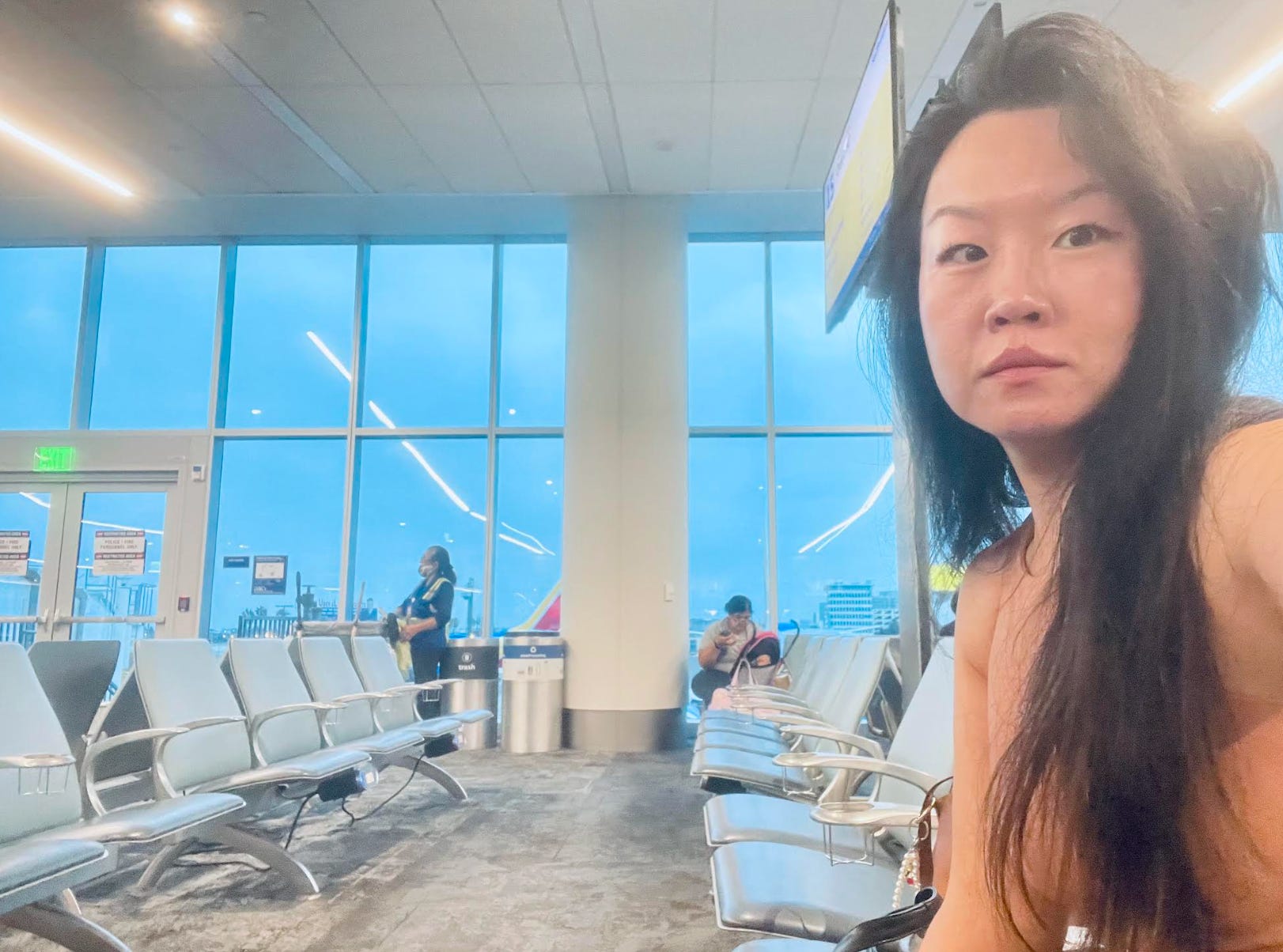 The writer waiting for a flight at her gate.