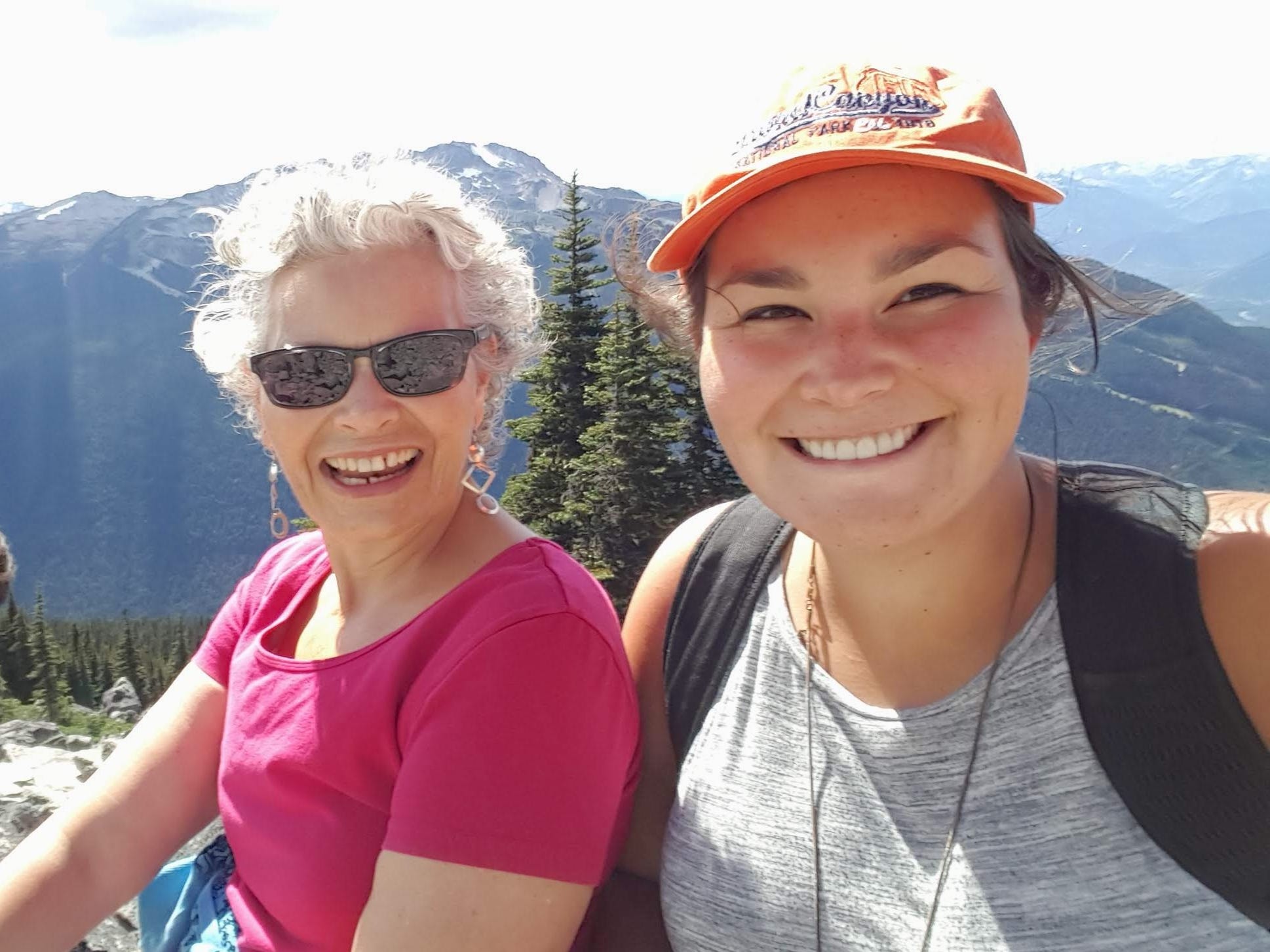 The author poses with her mother on a mountain vista in 2016.