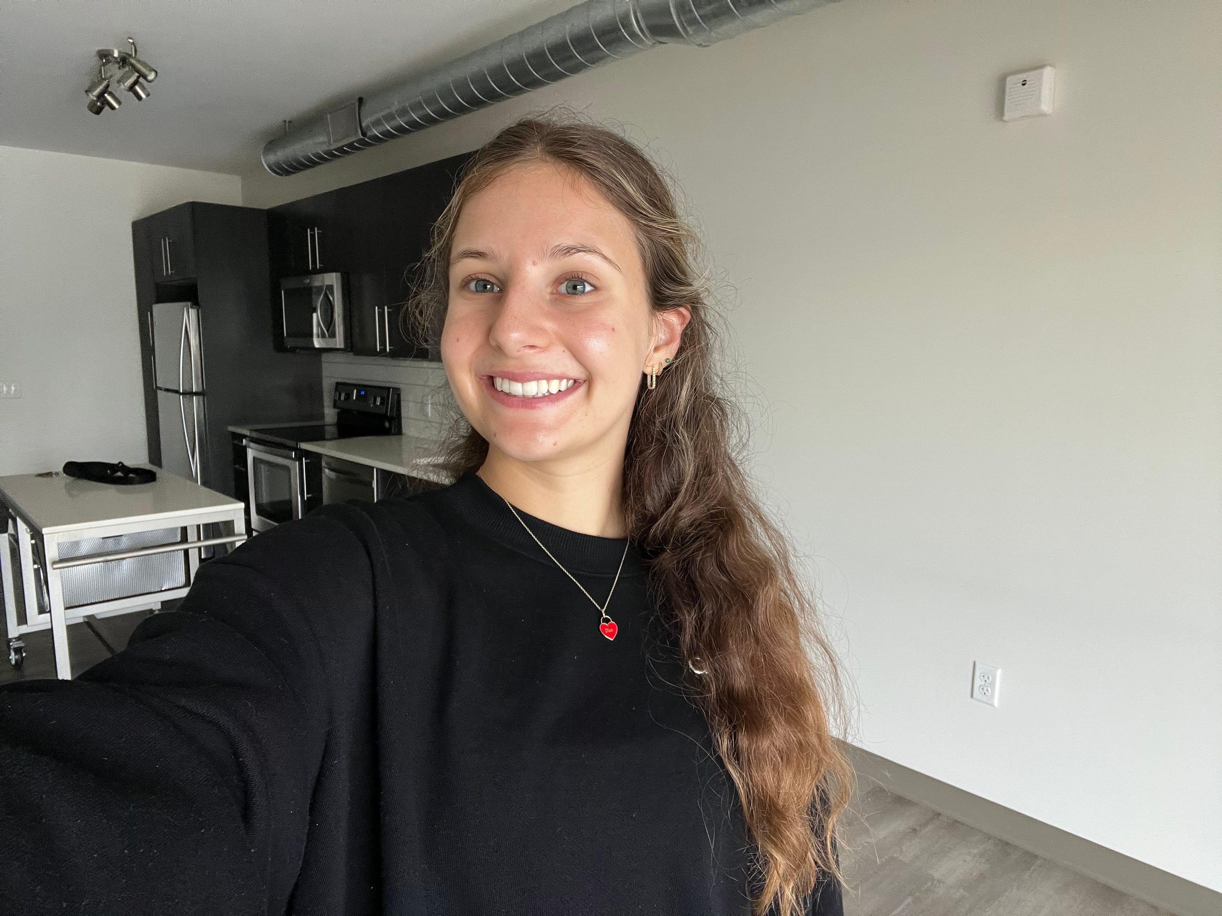 The author posing for a selfie in her new apartment.