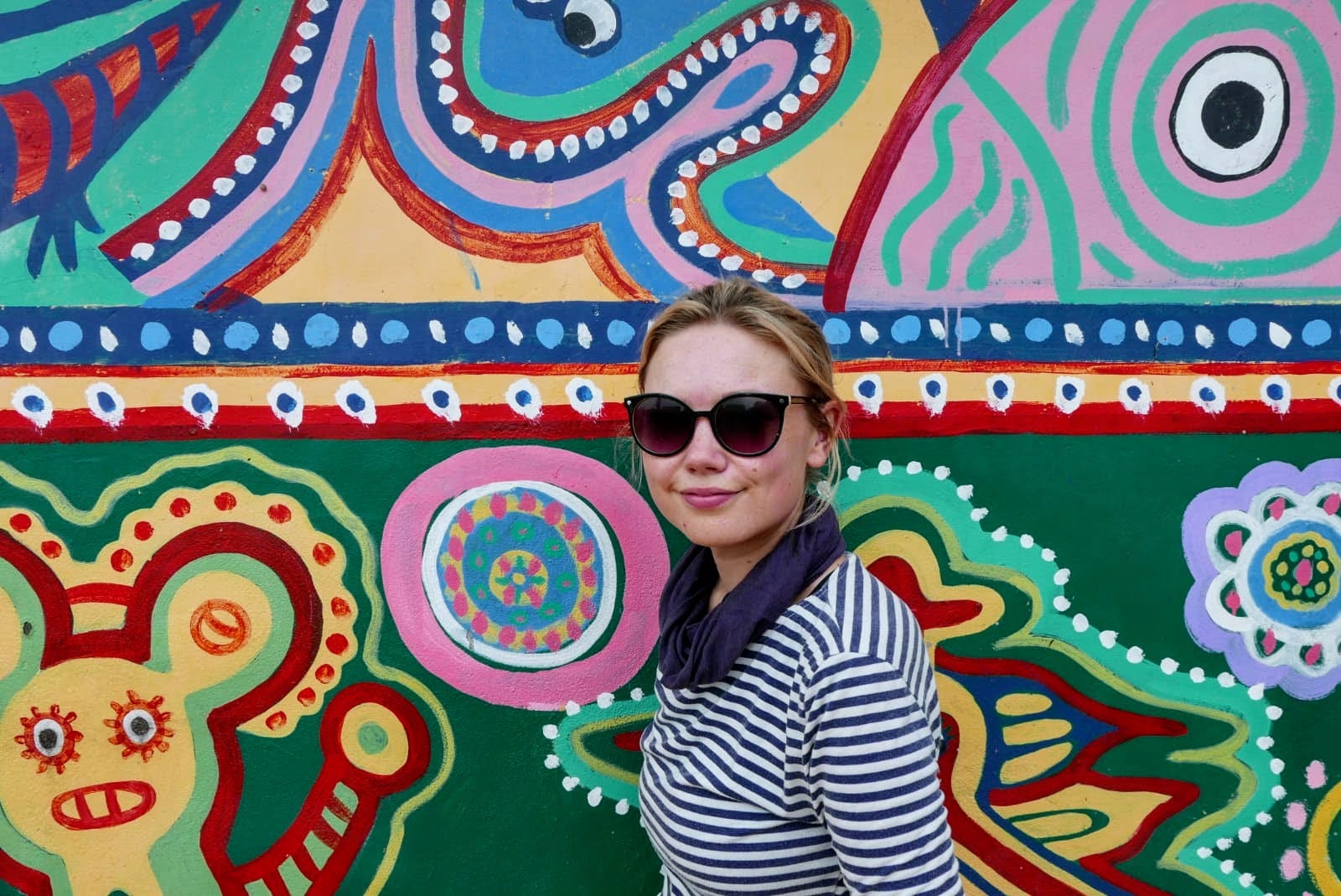 The author in front of a mural wall.