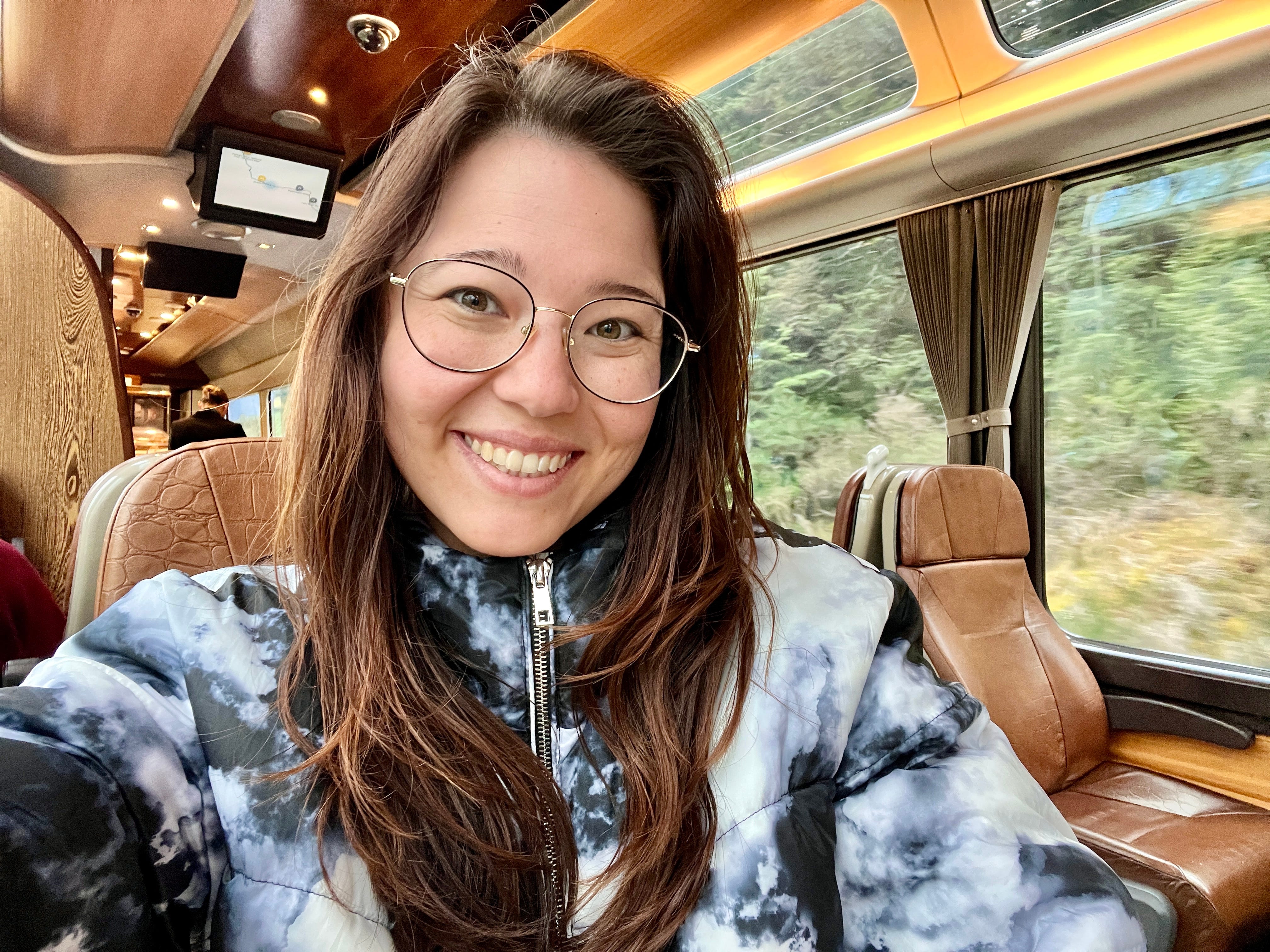 Author Ashley Probst smiling on TranzAlpine train in New Zealand