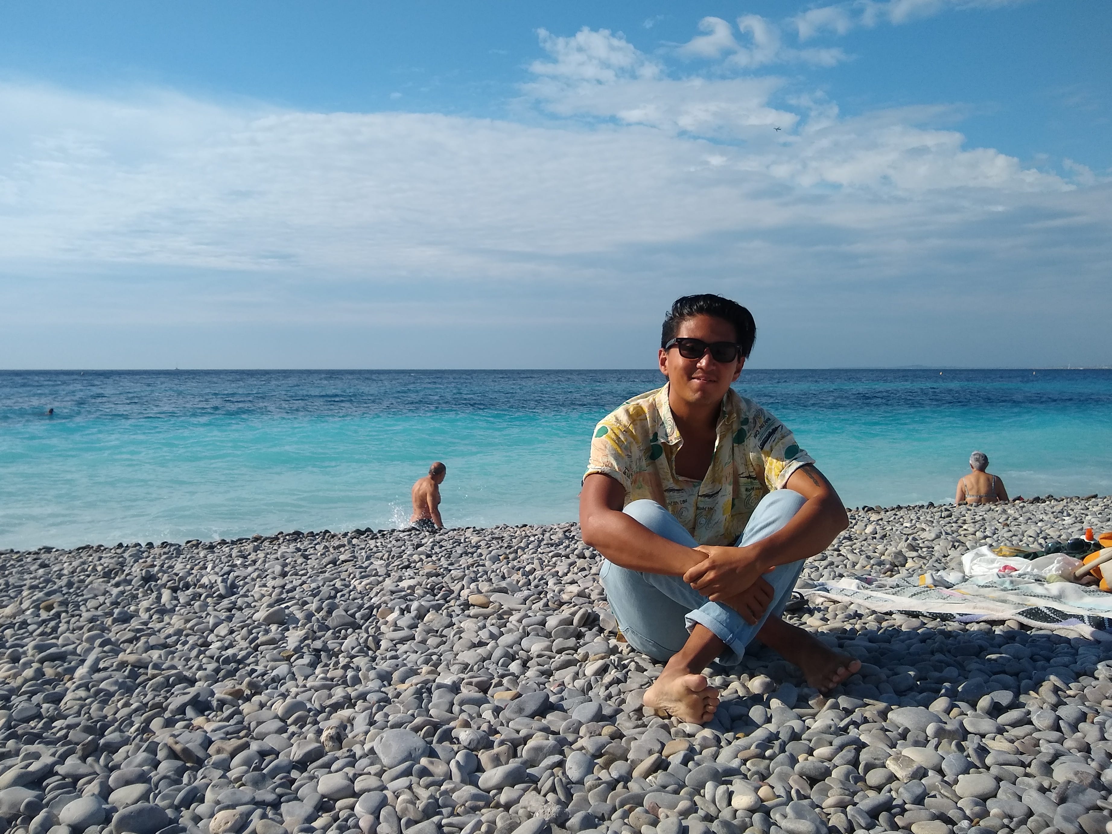 tino roco on beach with water in background