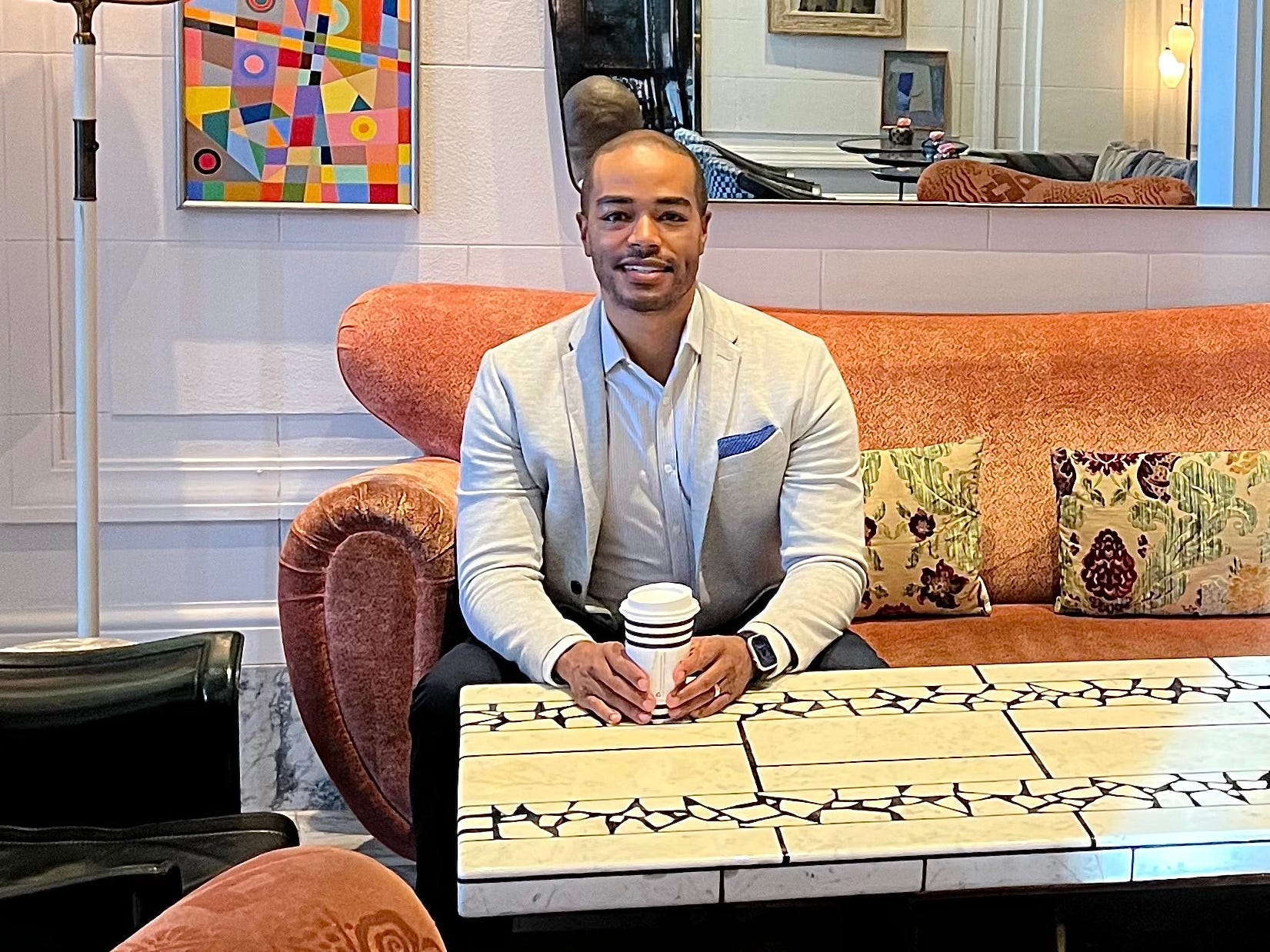 Robert E. Williams sitting in a chair and smiling
