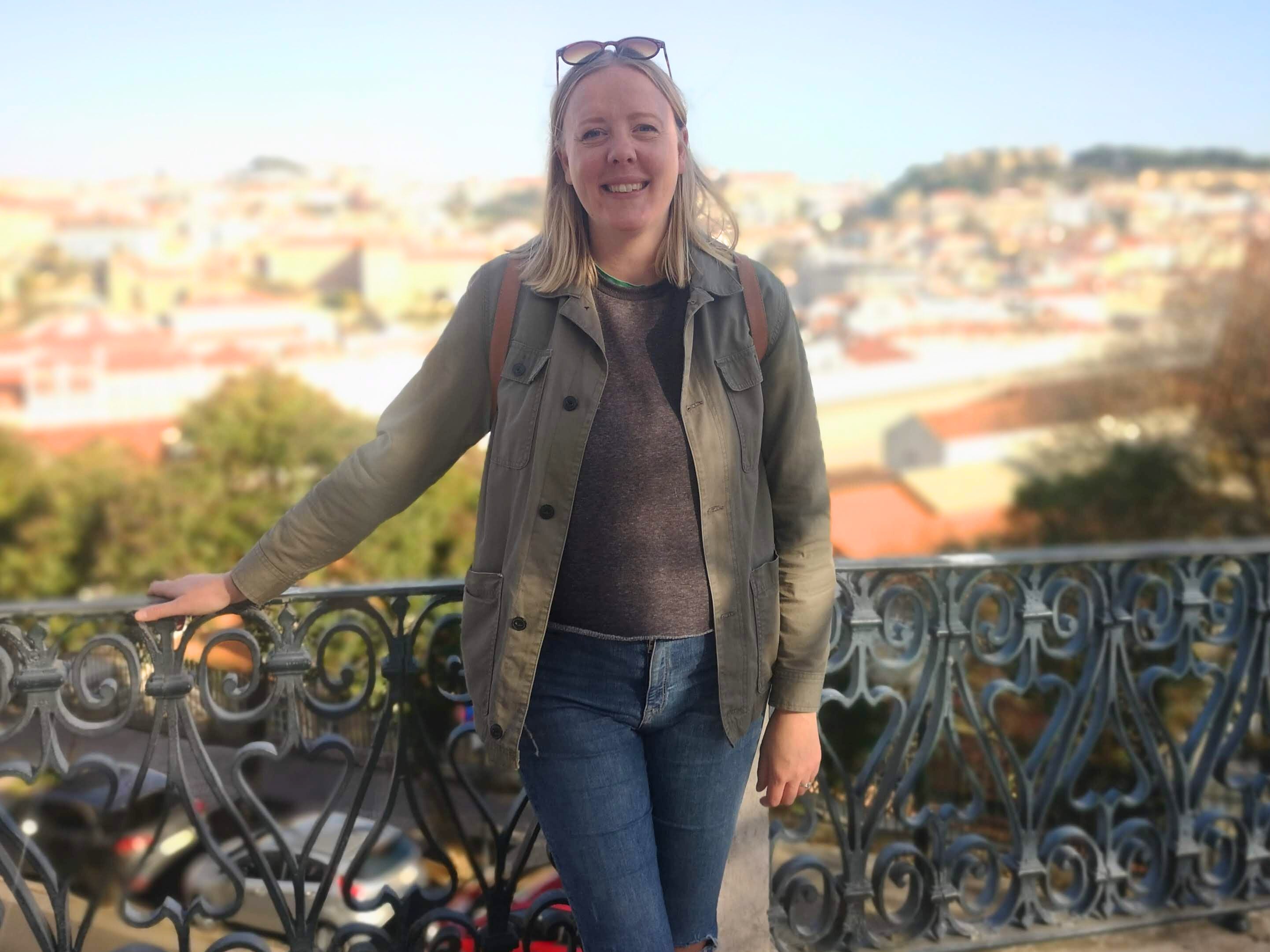 Charlie Brown standing with a view of Lisbon behind her.
