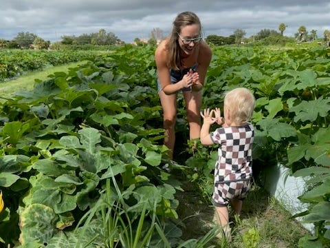 The author with her son in a field of pumpkins.