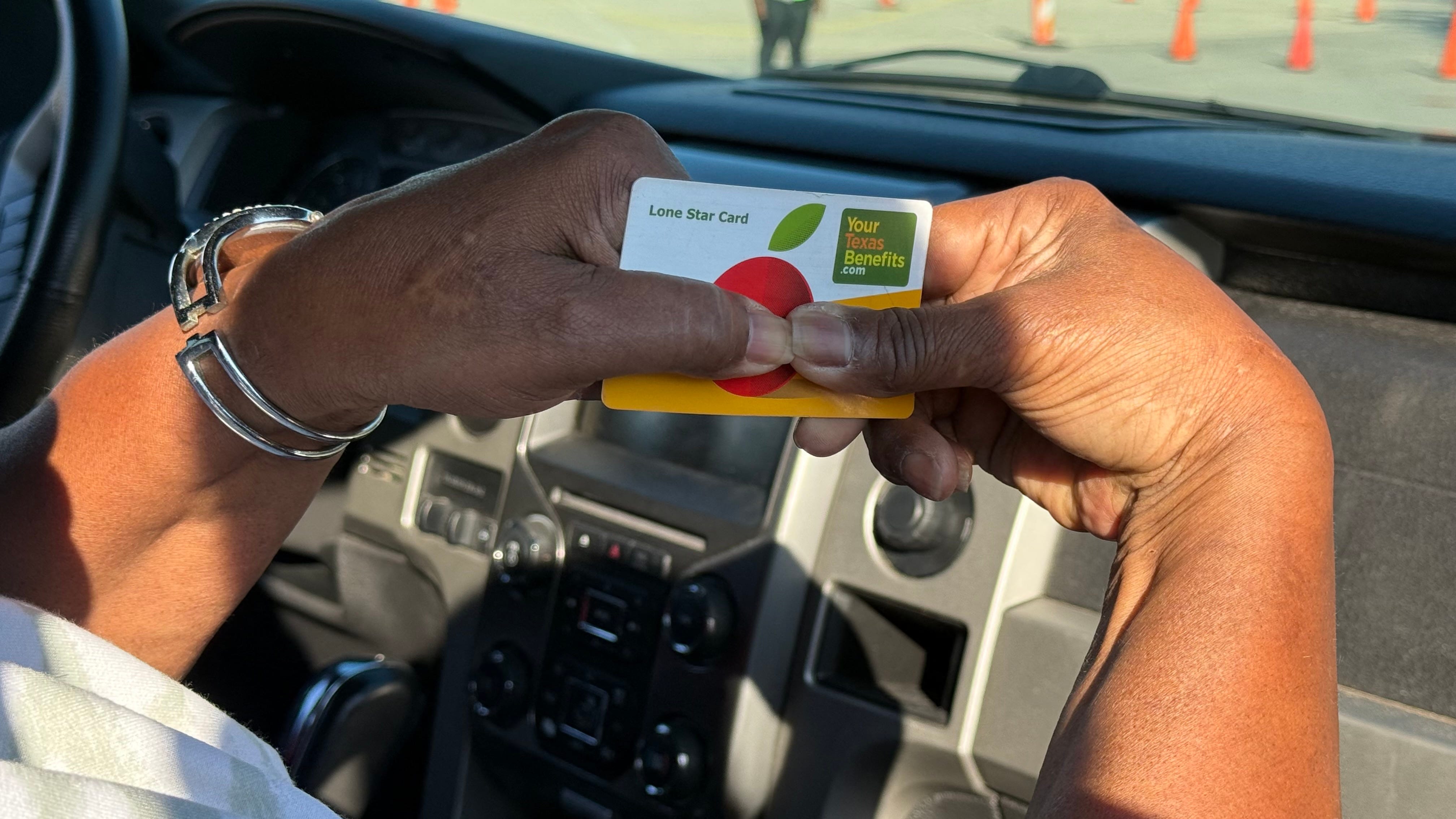 Hands hols a SNAP card