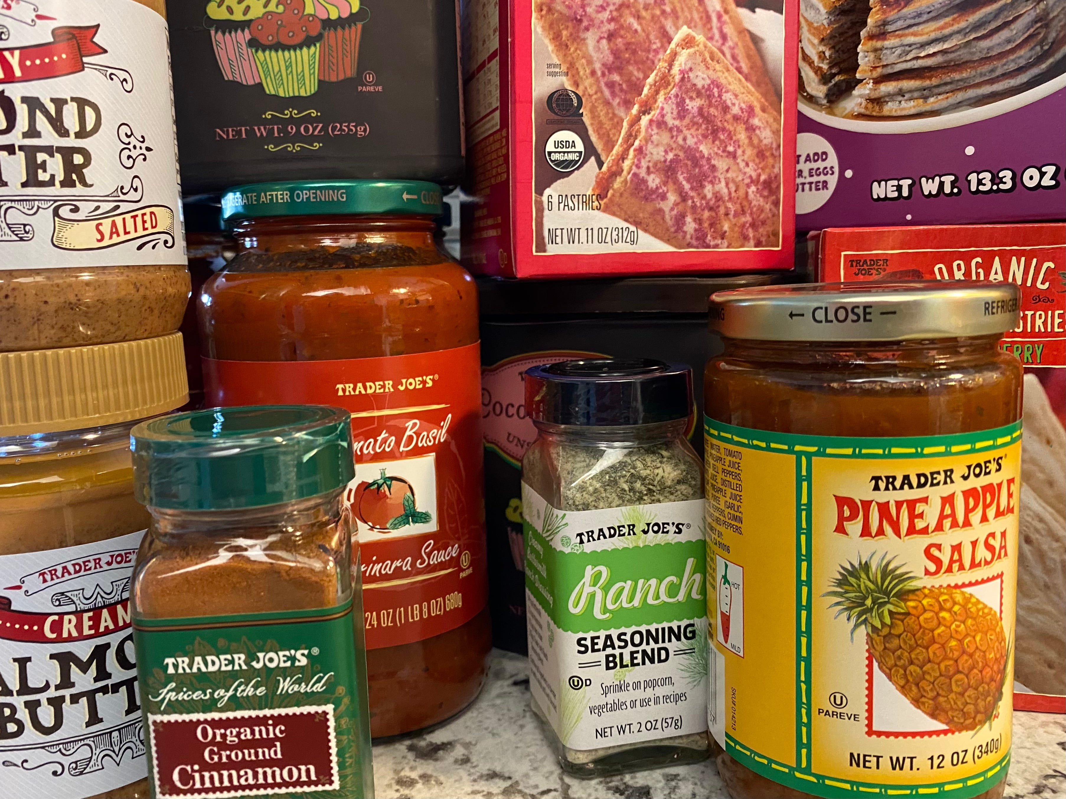 A collection of Trader Joe's groceries, including ranch seasoning, cinnamon, pineapple salsa, and more.