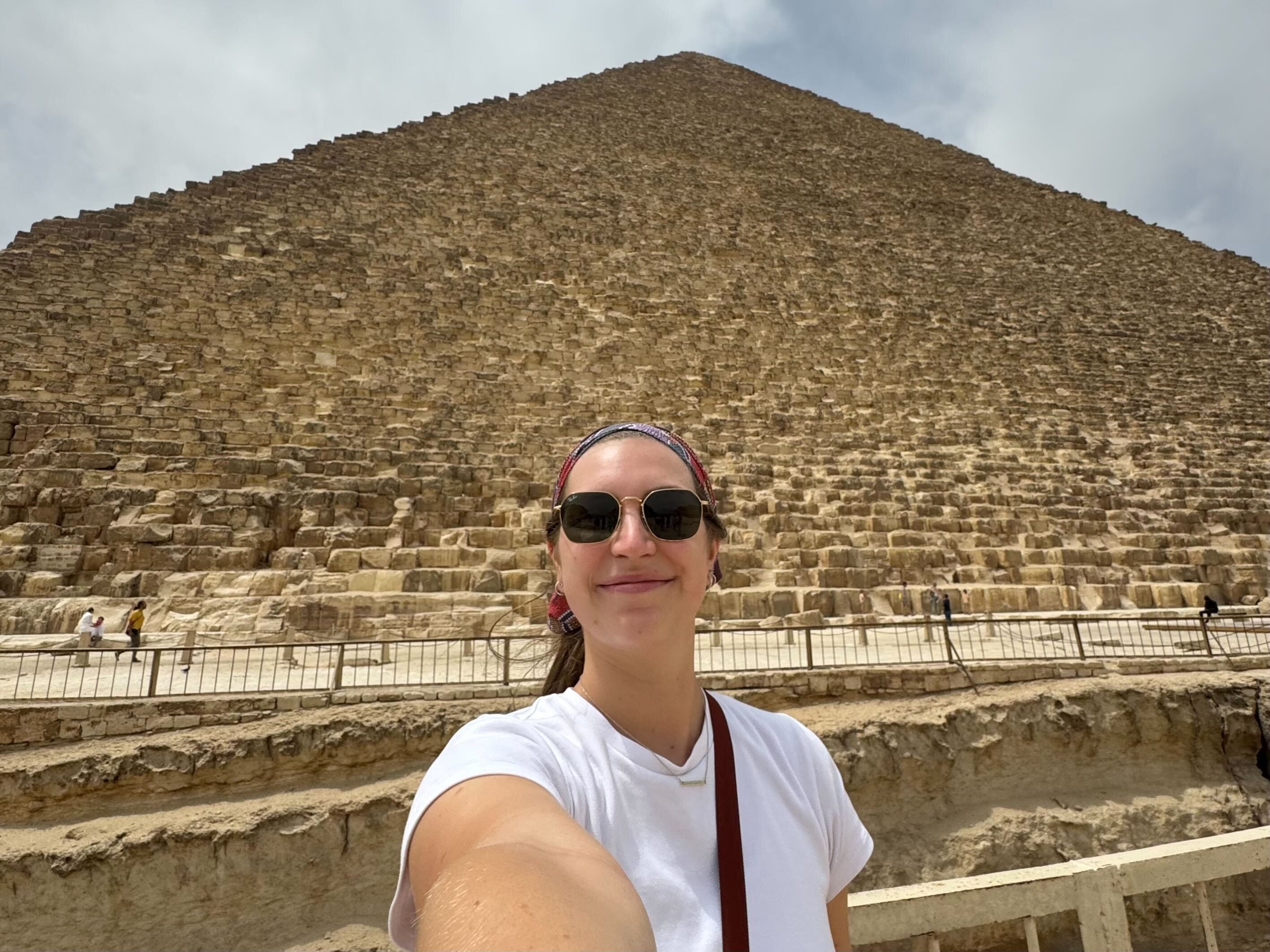 Hannah poses in front of one of the Pyramids of Giza.