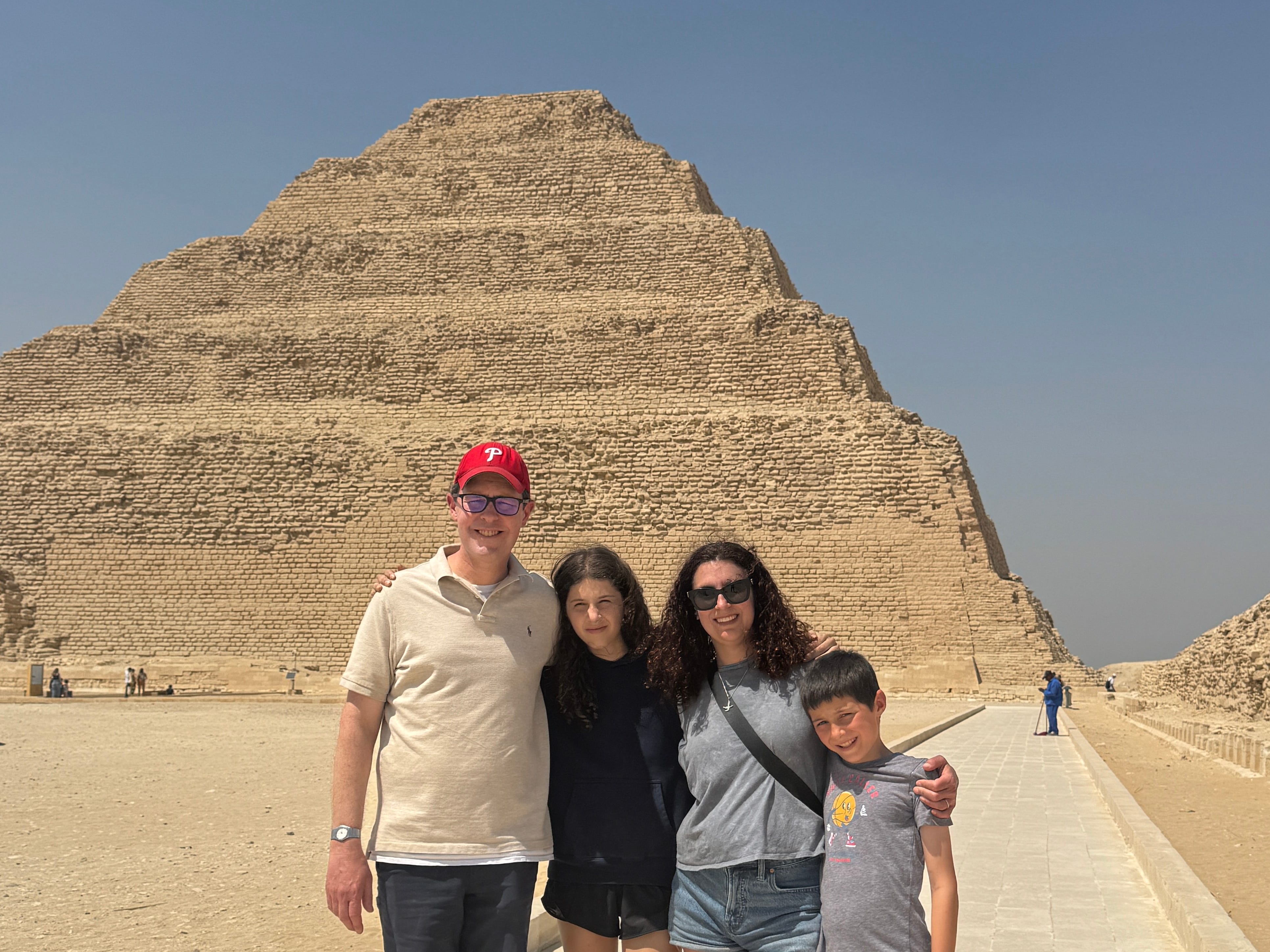 The author poses at a pyramid with her family.