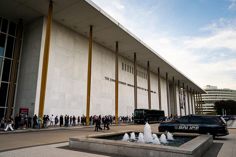 People wait in line prior to a prayer vigil for political activist Charlie Kirk outside the John F. Kennedy Center for the Performing Arts on September 14, 2025 in Washington, DC. Kirk was shot and killed by a gunman on September 10 while speaking at Utah Valley University. (Photo by Al Drago/Getty Images)