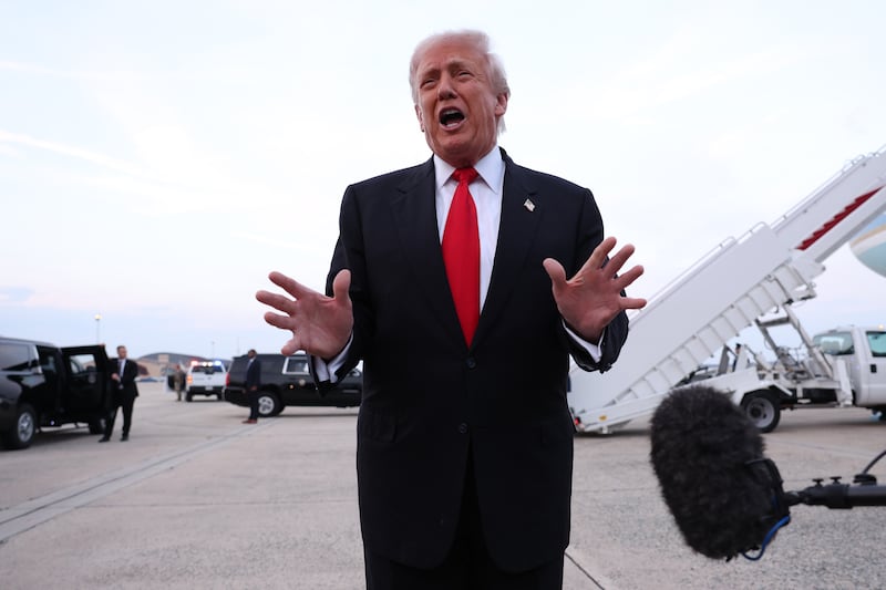 President Donald Trump gives brief remarks to members of the press after exiting Air Force One on November 9, 2025 at Joint Base Andrews, Maryland.