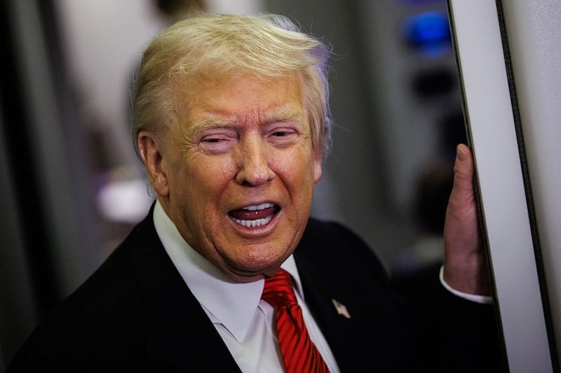 U.S. President Donald Trump speaks to reporters aboard Air Force One en route to the White House on November 2, 2025 after taking off from Palm Beach International Airport in West Palm Beach, Florida.