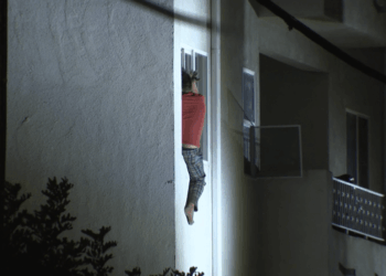 Man throwing items in L.A. apartment building hangs out of window