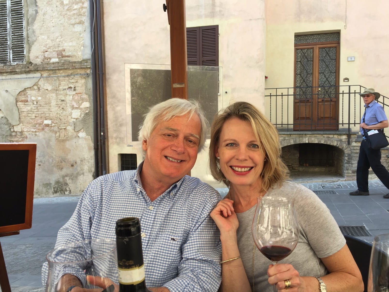 The writer and her husband sharing a glass of wine on a trip.