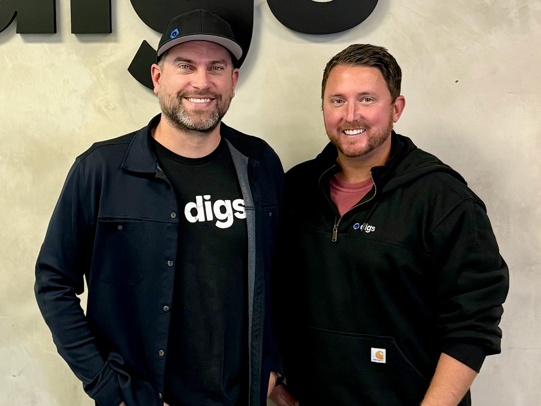 Digs cofounders by Frackiewicz and Ryan Fink, wearing black clothes with the company's logo.