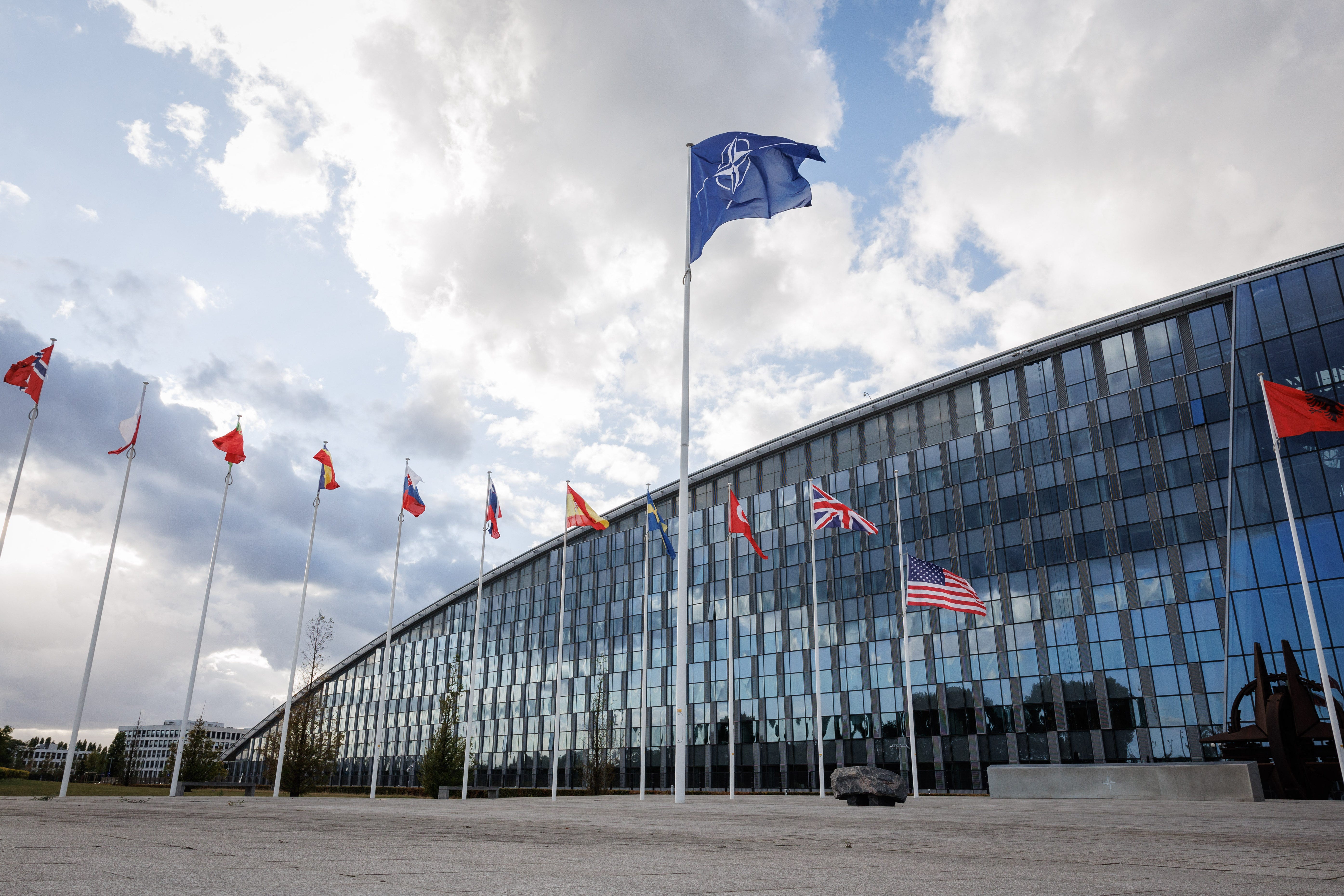 Flags of NATO members fly at the NATO headquarters in Brussels.