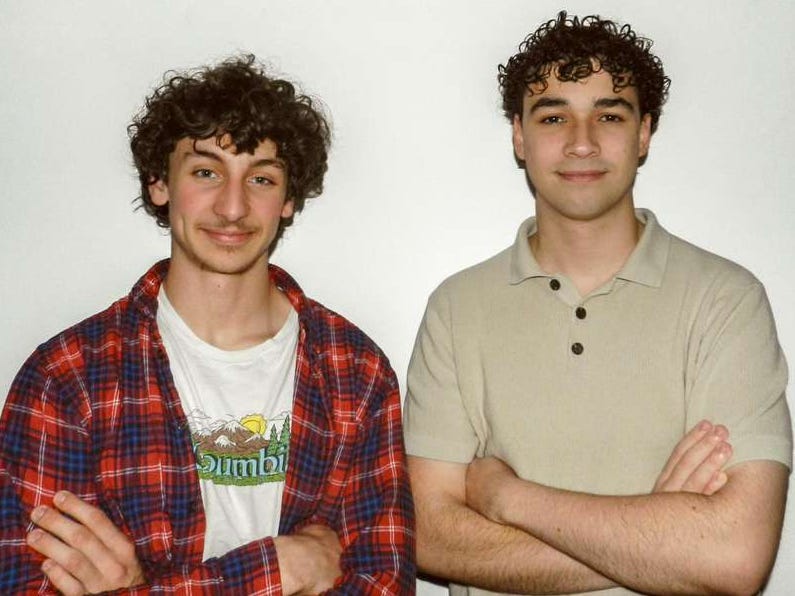 Georges Casassovici and Mathieu Rihet, standing in front of a white wall with their arms crossed.