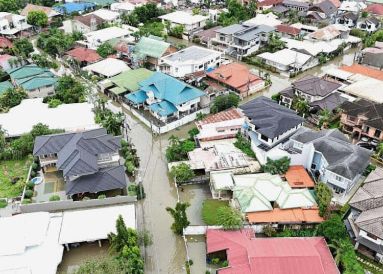 Typhoon leaves at least 2 dead, traps people on roofs and submerges cars in central Philippines