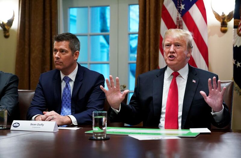 US President Donald Trump, with US Congressman Sean Duffy (L), speaks in the Cabinet Room of the White House on January 24, 2019.