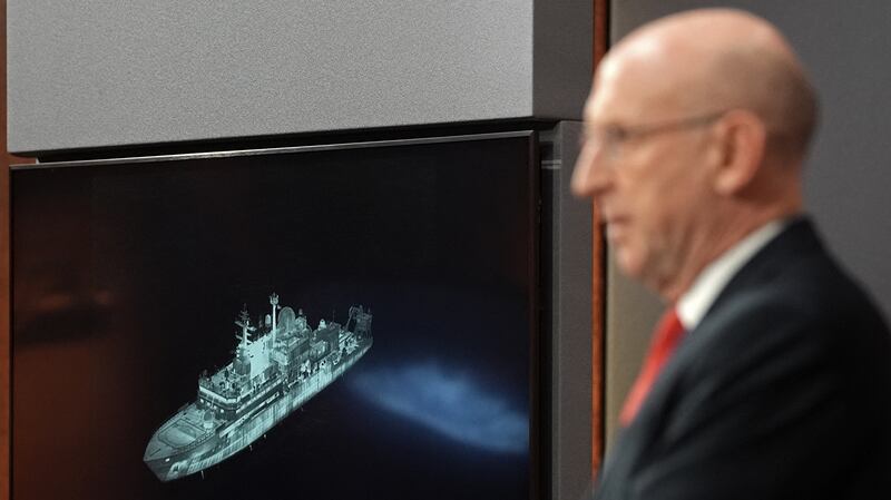 Britain's Defense Secretary John Healey, backdropped by a screen displaying an image of Russian military ship Yantar, operating off the northern coast of Scotland.