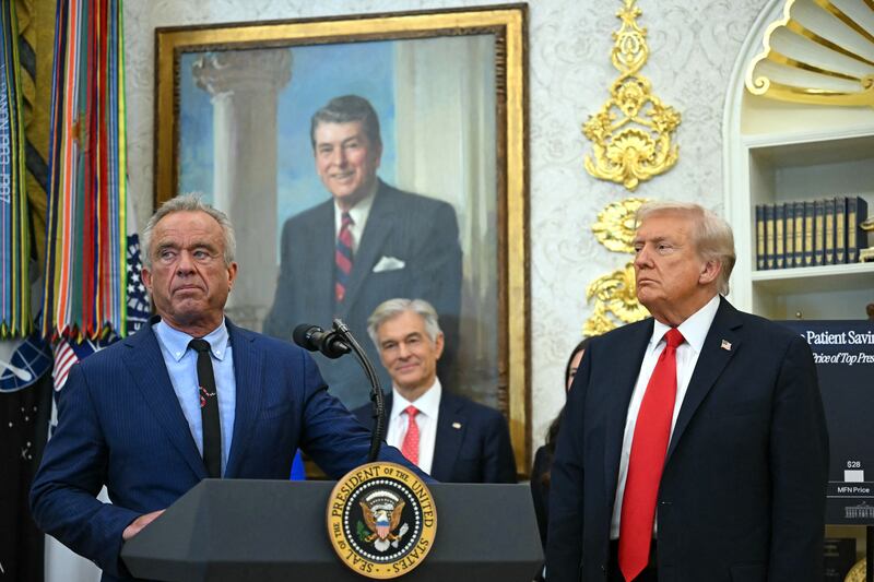 US President Donald Trump listens to US Secretary of Health and Human Services Robert F. Kennedy Jr. (L) during an announcement in the Oval Office.