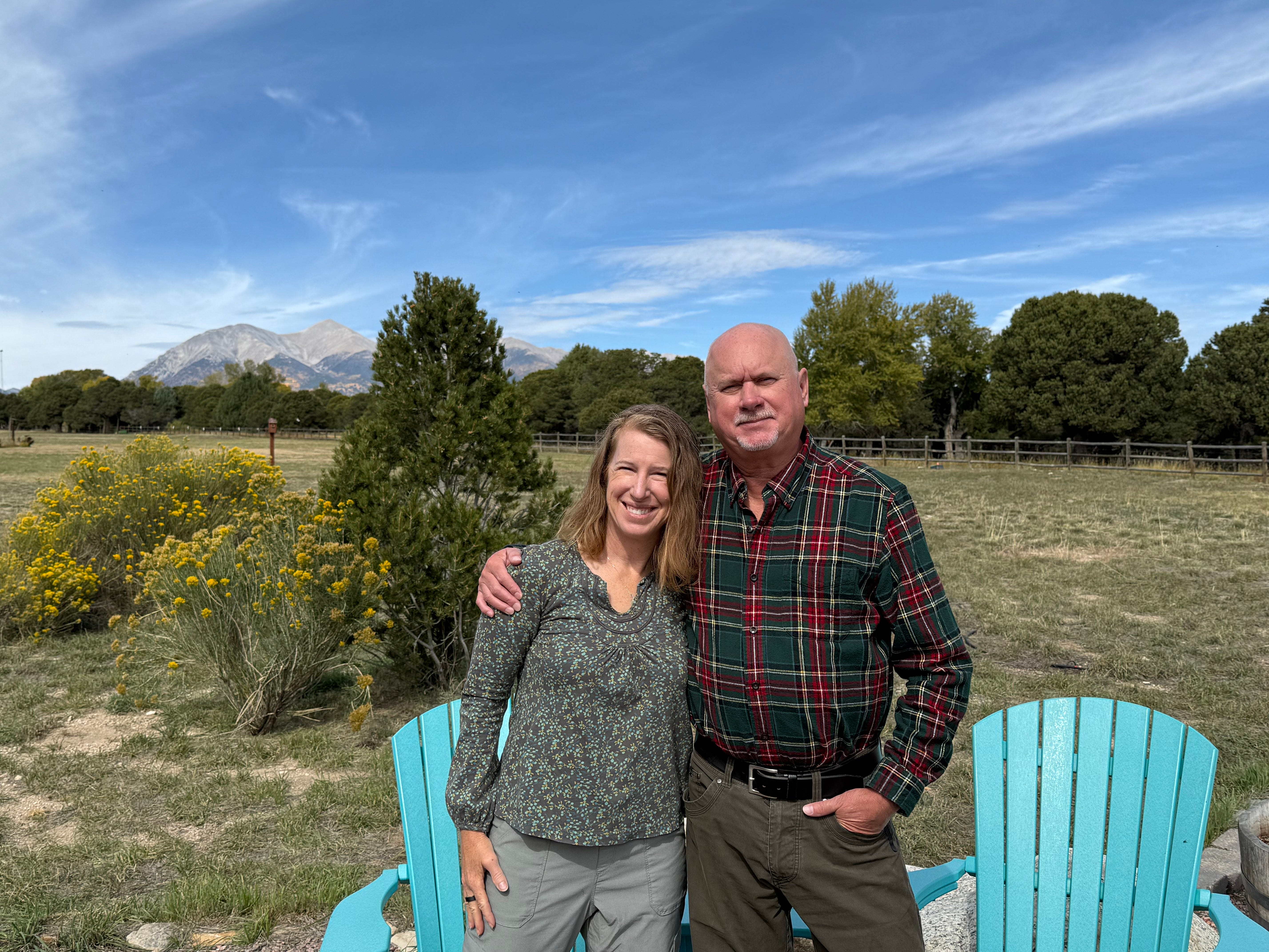 Author Becki Rupp standing with man smiling with mountains in distance
