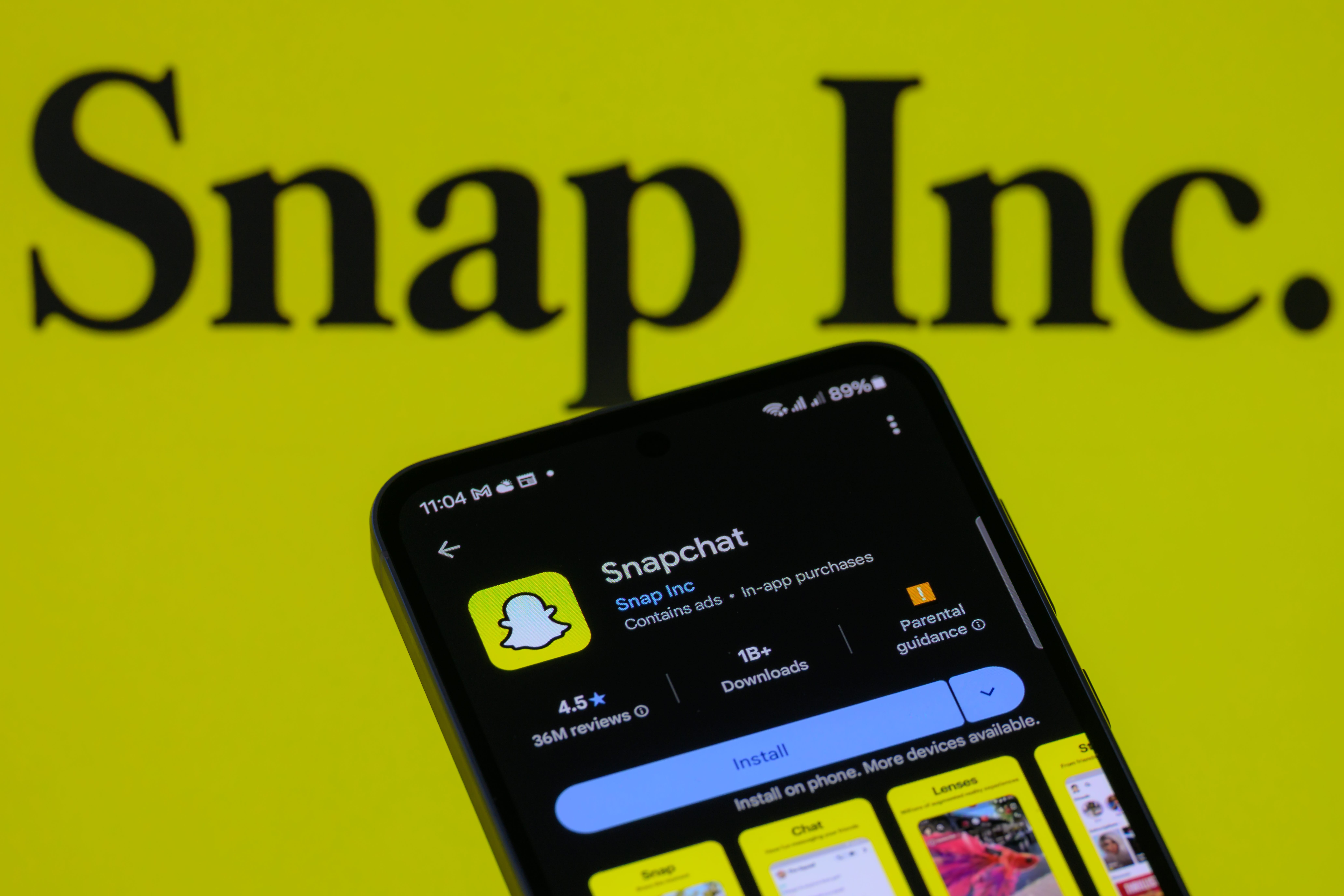 The Snapchat app displays on a mobile phone with Snap Inc. in the background in this photo illustration in Brussels, Belgium, on August 9, 2025.