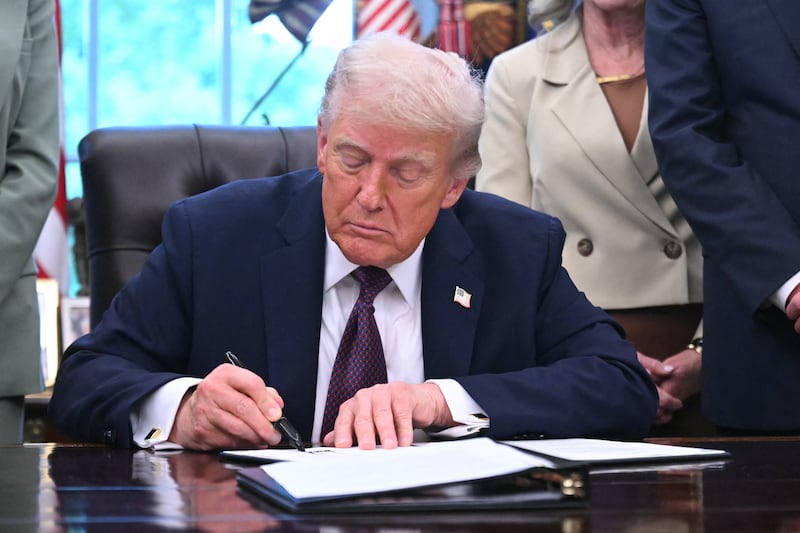 US President Donald Trump signs an order sending National Guard to Memphis, in the Oval Office of the White House in Washington, DC, on September 15, 2025. US President Donald Trump said on September 15 he was signing an order sending a federal