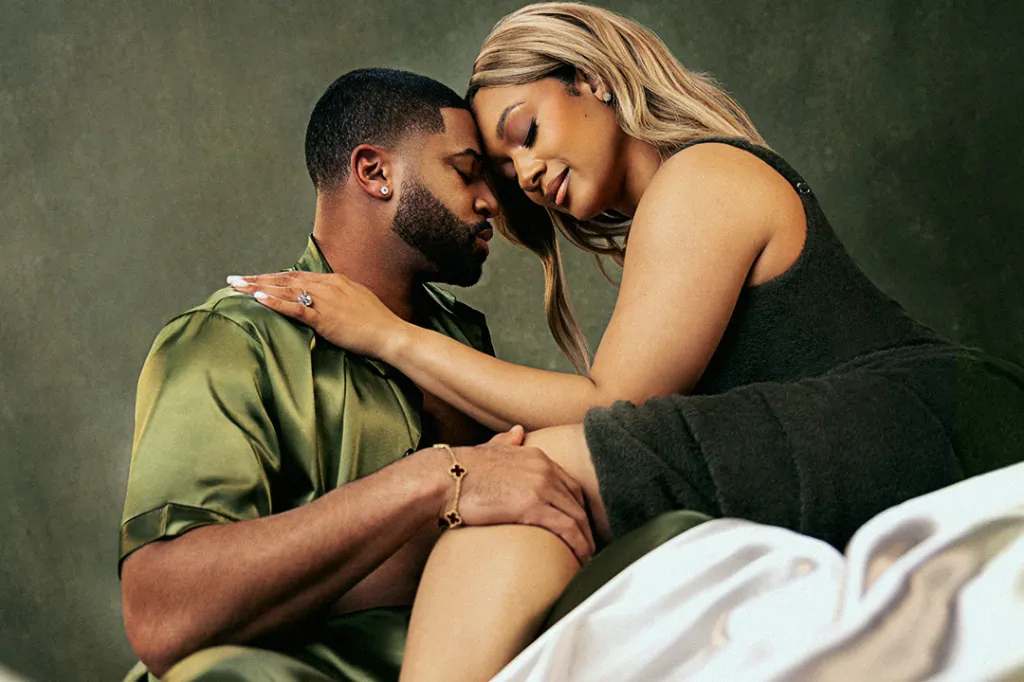 A man and woman, heads touching, looking intimate.