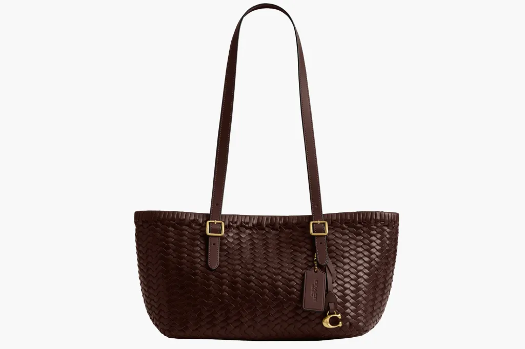 Brown woven leather tote bag with shoulder straps and gold hardware.