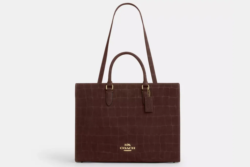 Brown Coach tote bag with alligator texture.
