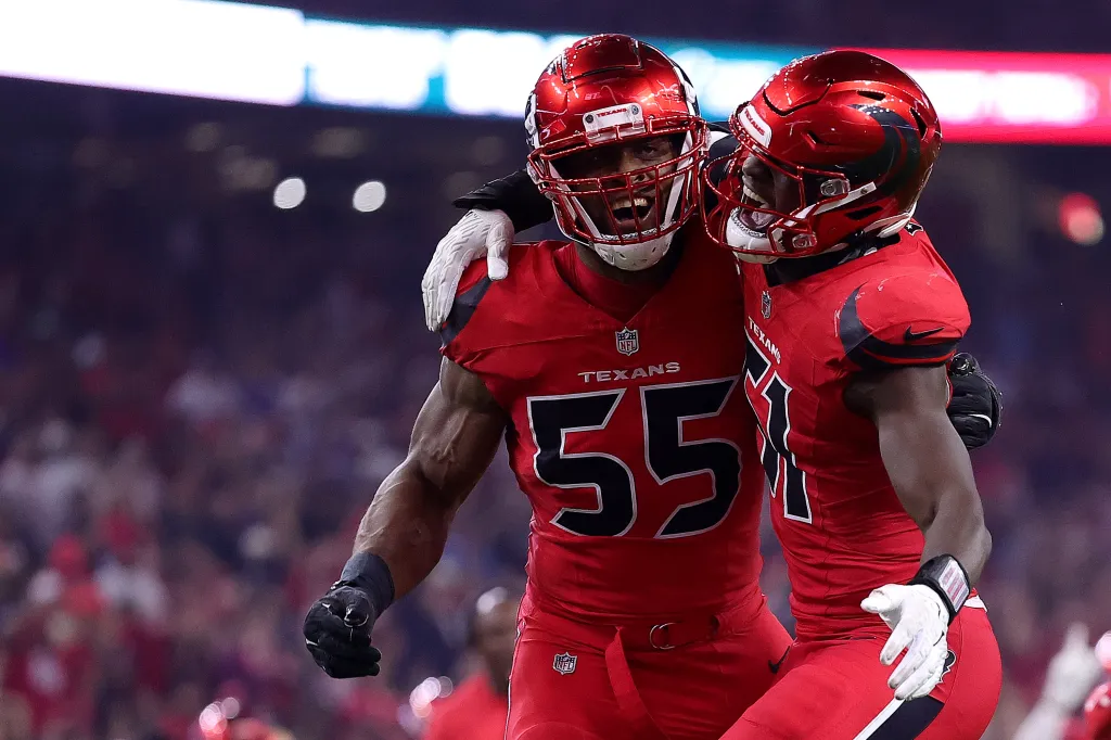 Danielle Hunter #55 and Will Anderson Jr. #51 of the Houston Texans celebrate a sack.