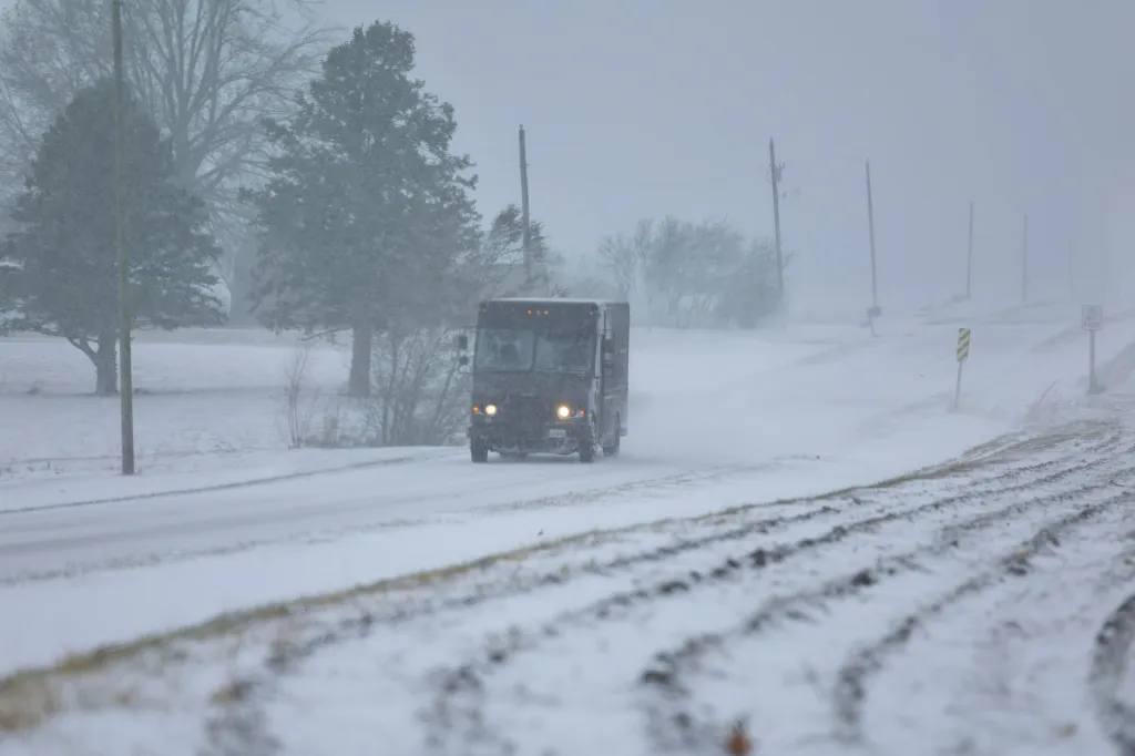 A truck making its way through the snow in Funks Grove, Ill. on Nov. 29, 2025.