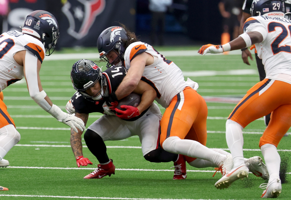 Denver Broncos linebacker Alex Singleton (49) tackles Houston Texans wide receiver Jaylin Noel (14 during the second half at NRG Stadium.