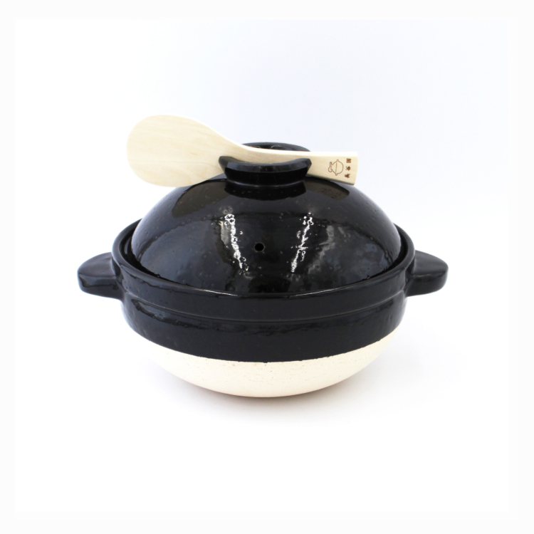 A white donabe with a black lid. 