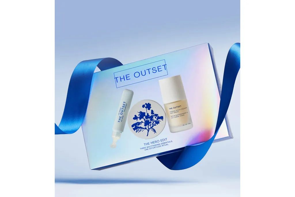 A gift box from The Outset with a blue ribbon containing 