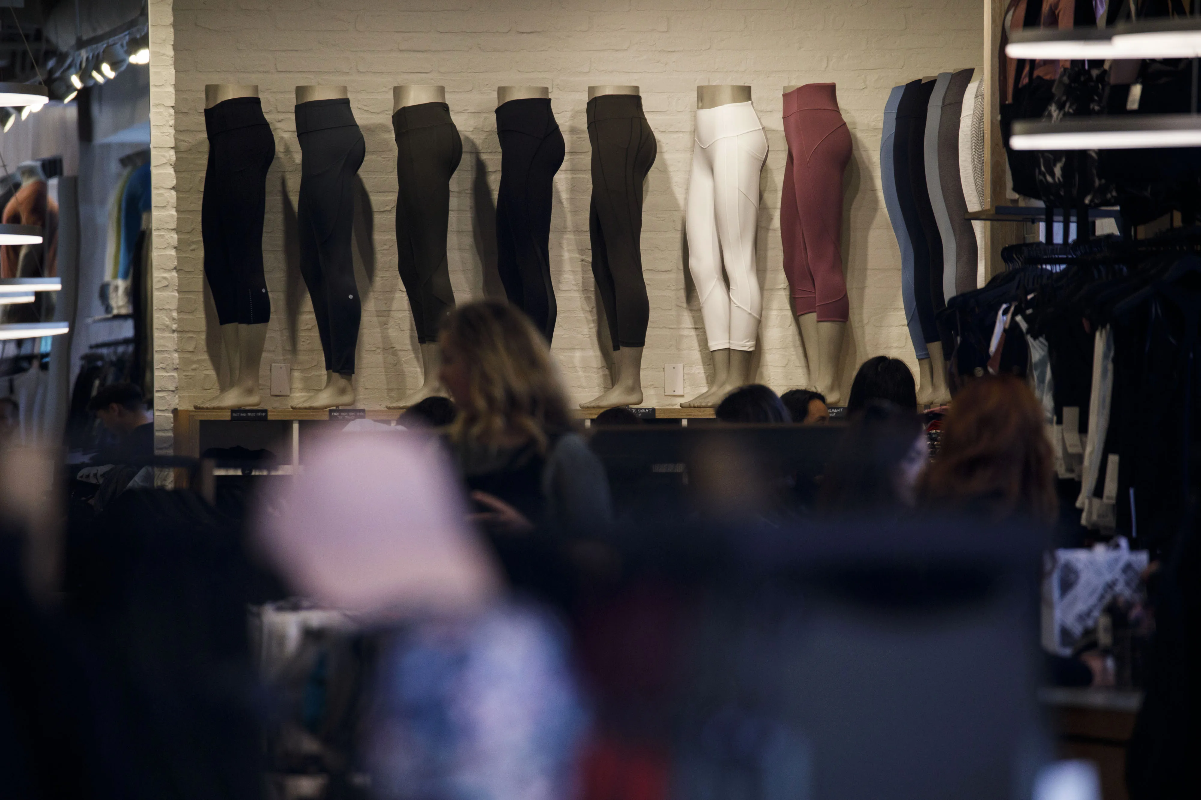 Mannequin legs wearing leggings in a store display