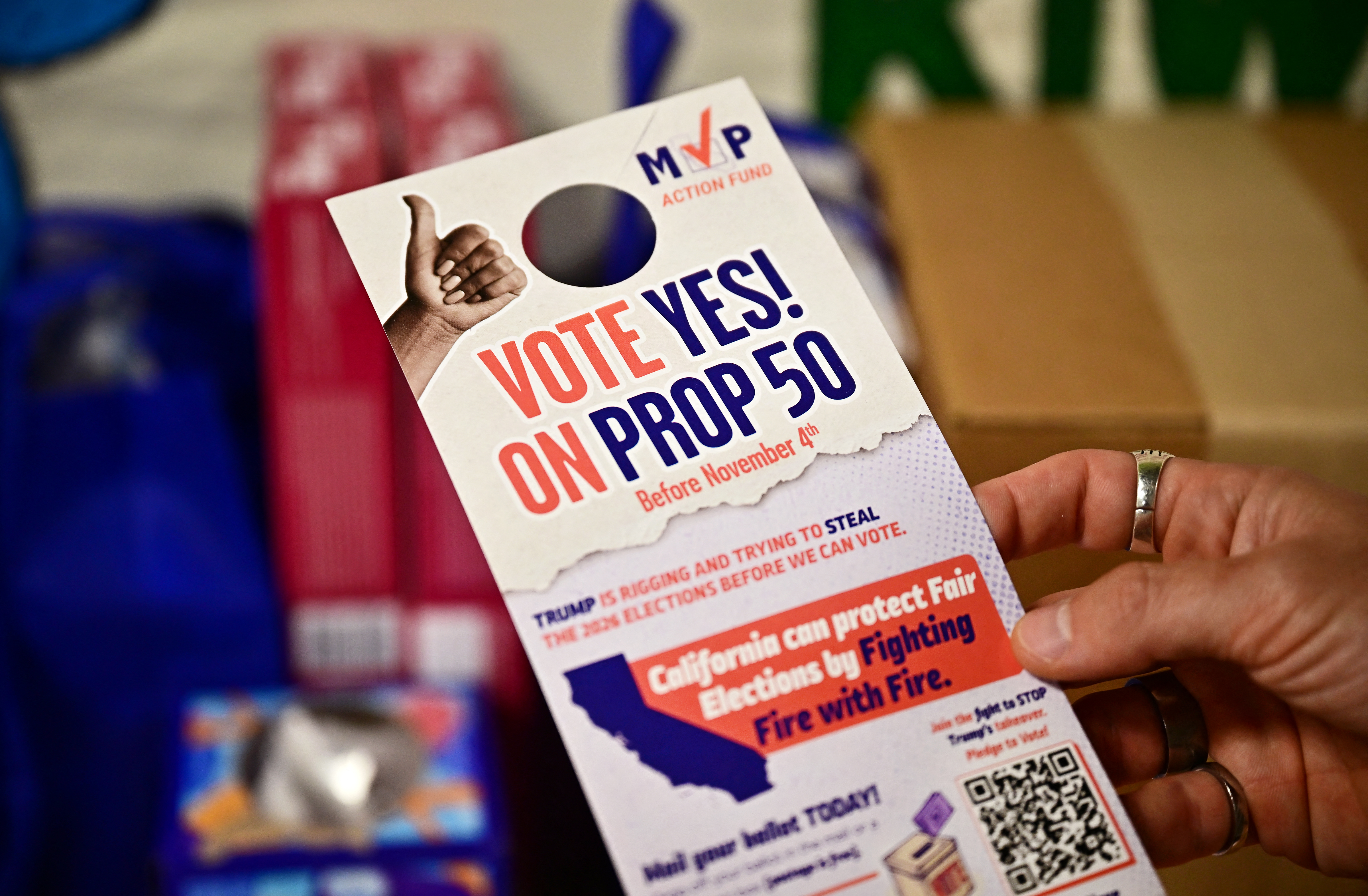 A Vote Yes on Prop 50 door hanger is displayed. It reads “Vote Yes! On Prop 50.”