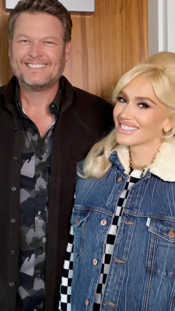 Gwen Stefani and Blake Shelton smiling at the camera.