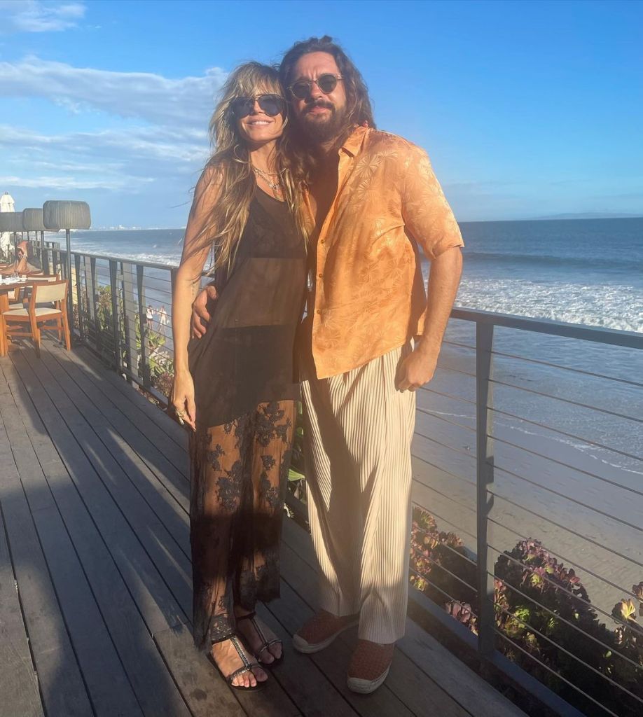 Heidi Klum and husband Tom Kaulitz pose for a photo overlooking the ocean.