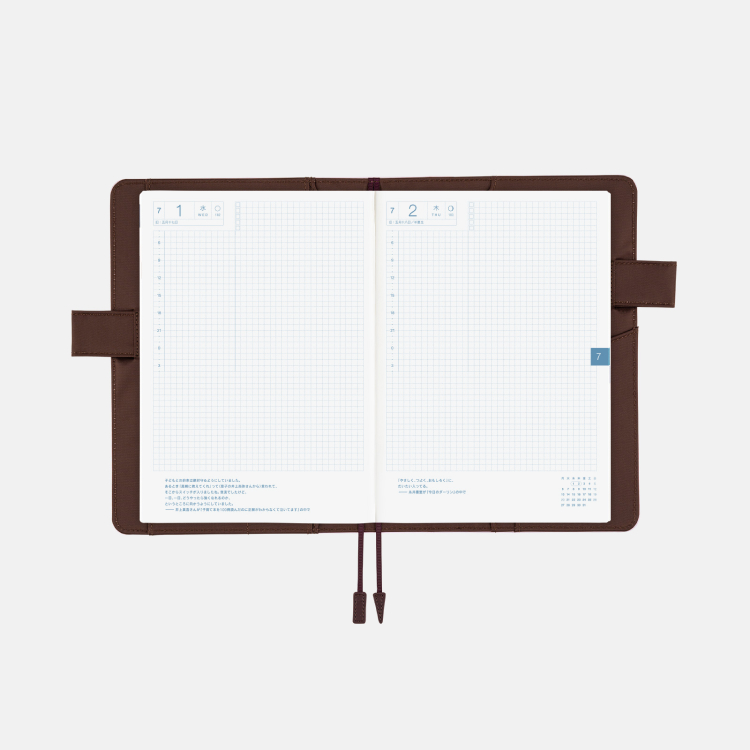 An open planner with a brown cover. 