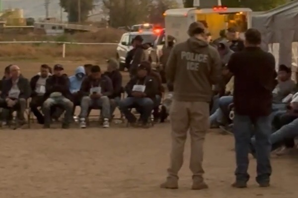 Federal immigration officials detain people during a raid at La Catedral Arena horse track in Wilder, Idaho, on Oct. 19, 2025.
