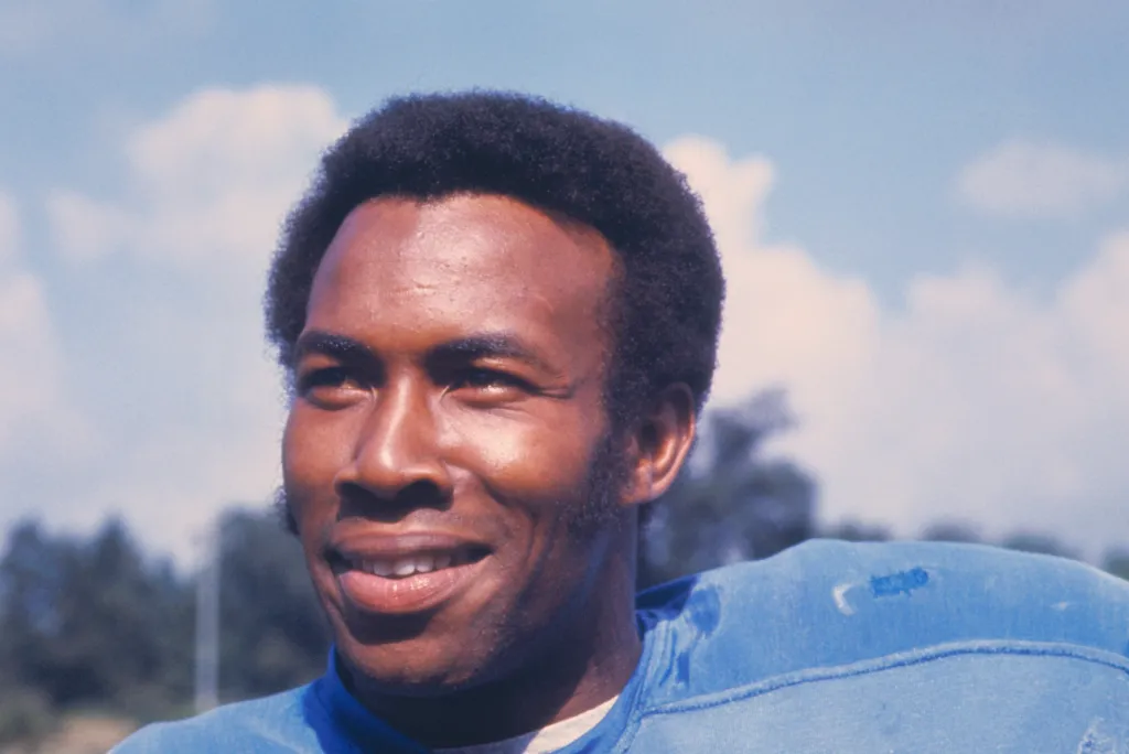 Headshot of Lem Barney, a Detroit Lions cornerback, smiling and looking to the right.