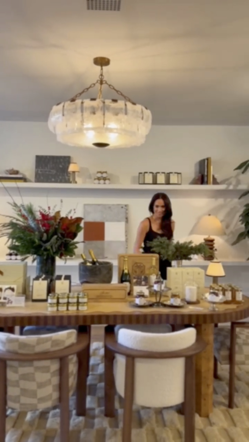 Meghan Markle at a Thanksgiving table laden with food and gifts.