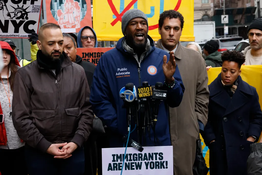 New York City Public Advocate Jumaane Williams speaking at an anti-ICE rally with a microphone and 