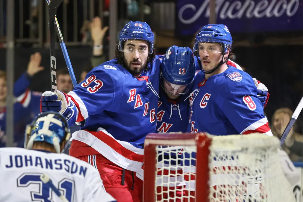 New York Rangers center J.T. Miller (8) celebrates with center Mika Zibanejad (93), and left wing Alexis Lafreniere (13) after scoring a goal in the second period against the Tampa Bay Lightning at Madison Square Garden. 