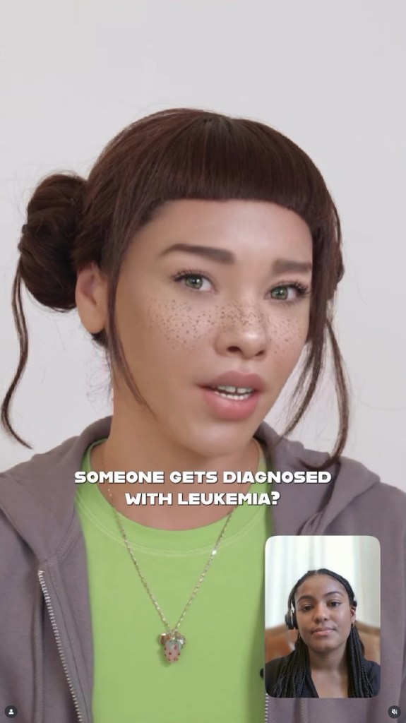 A woman with freckles and brown hair in a bun wears a green shirt and a grey hoodie, speaking into the camera, with a small inset video call of another woman. Text on the screen reads, 