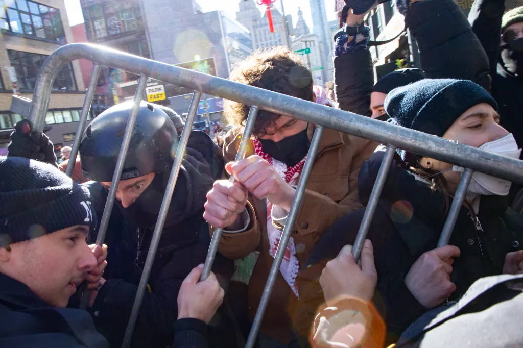 Protesters being pushed back from a federal law enforcement garage.