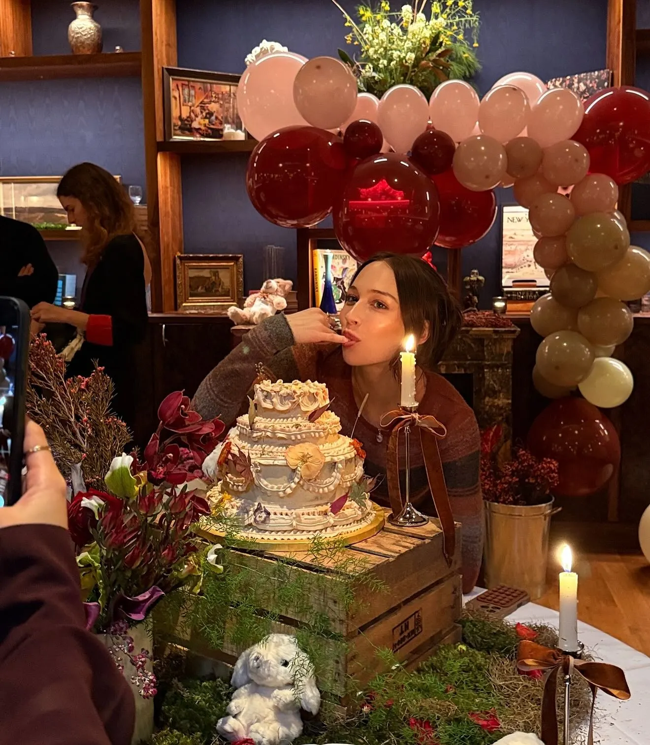 Elsie Hewitt licking cake frosting at her bunny-themed baby shower.