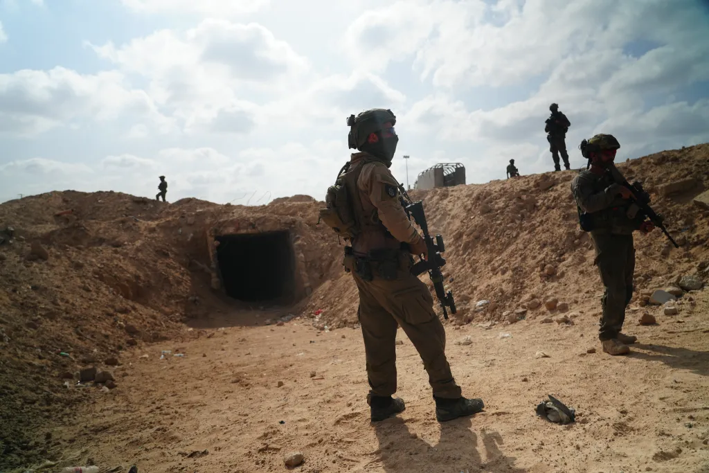 Israeli soldiers stand at the entrance of a tunnel in Rafah.